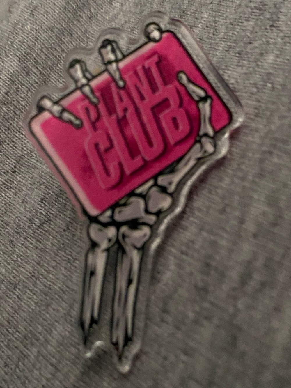 Plant Club collectible Pin featuring a skeleton hand holding pink bar of soap